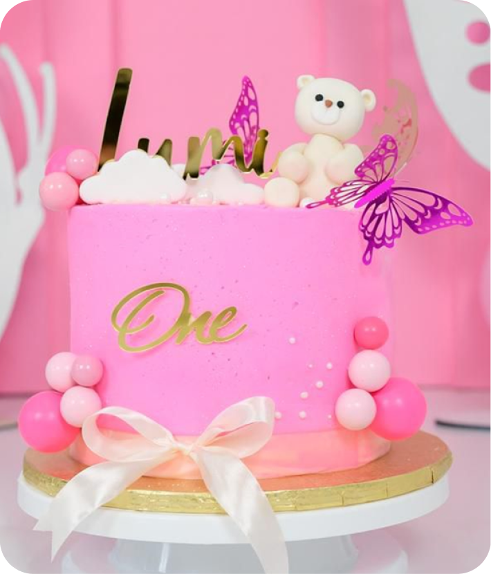 Beautiful assortment of AmaSwazi Bakes & Co. cupcakes with cream frosting and fresh raspberries